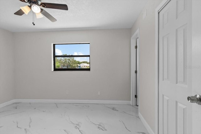 6370 Elmhurst Dr, Pinellas Park, FL 33782 - unfurnished room with marble look tile flooring, ceiling fan, and a textured ceiling