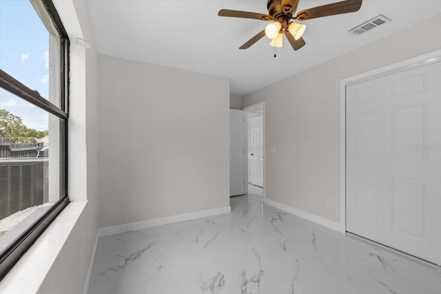 6370 Elmhurst Dr, Pinellas Park, FL 33782 - unfurnished bedroom featuring a ceiling fan and marble finish floors