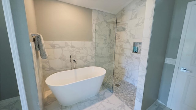 28826 Windover St, Wesley Chapel, FL 33545 - full bathroom with a soaking tub, marble look tiles, a marble finish shower, and tile walls