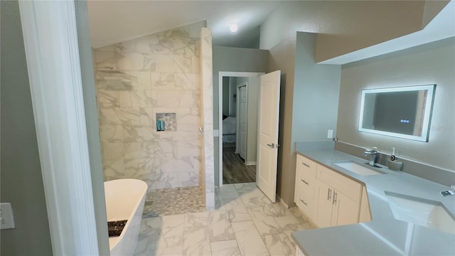 28826 Windover St, Wesley Chapel, FL 33545 - bathroom with marble look tiles, a freestanding tub, vanity, a walk in shower, and lofted ceiling