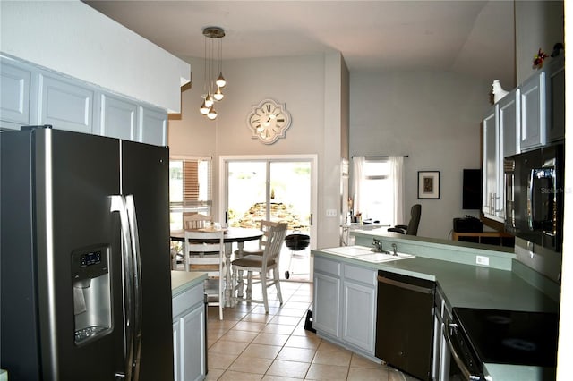 28826 Windover St, Wesley Chapel, FL 33545 - kitchen featuring appliances with stainless steel finishes, high vaulted ceiling, light tile patterned floors, a peninsula, and pendant lighting