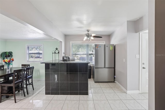 109 Emerald Ln, Largo, FL 33771 - kitchen featuring freestanding refrigerator, plenty of natural light, a ceiling fan, and light tile patterned floors