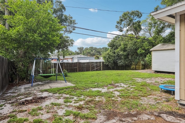 109 Emerald Ln, Largo, FL 33771 - fenced backyard featuring a playground, a trampoline, and a storage shed