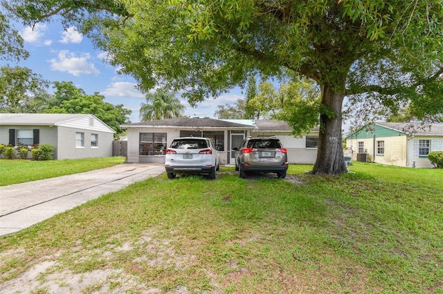 1711 W Followthru Dr, Tampa, FL 33612 - view of front of house with a front yard, concrete driveway, and a garage