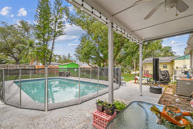 1711 W Followthru Dr, Tampa, FL 33612 - view of swimming pool featuring ceiling fan, a patio, and a fenced backyard