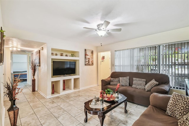 1711 W Followthru Dr, Tampa, FL 33612 - living room featuring a ceiling fan, light tile patterned floors, and built in shelves