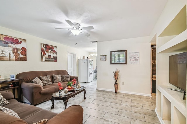 1711 W Followthru Dr, Tampa, FL 33612 - living room with ceiling fan, light tile patterned floors, and a chandelier
