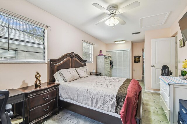 1711 W Followthru Dr, Tampa, FL 33612 - bedroom featuring tile patterned floors, attic access, a closet, and a ceiling fan