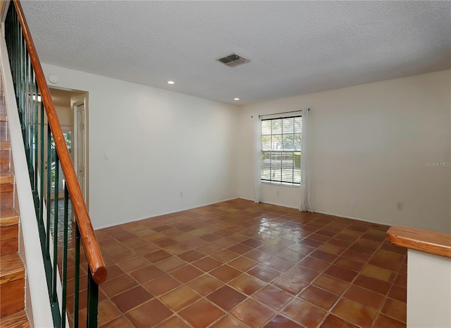 945 Hamilton Ct, Palm Harbor, FL 34683 - empty room with a textured ceiling, tile patterned floors, stairway, recessed lighting, and a smoke detector