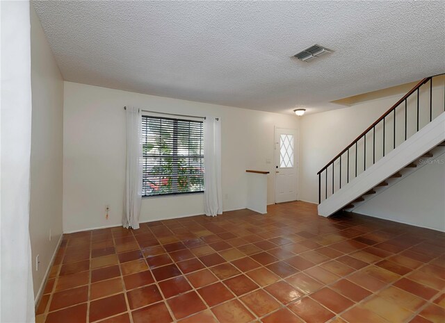 945 Hamilton Ct, Palm Harbor, FL 34683 - foyer with a textured ceiling, stairway, and tile patterned flooring