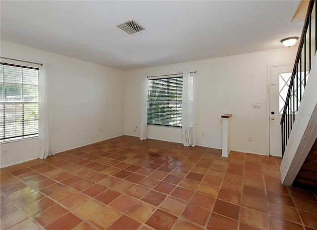 945 Hamilton Ct, Palm Harbor, FL 34683 - spare room with light tile patterned floors and stairway
