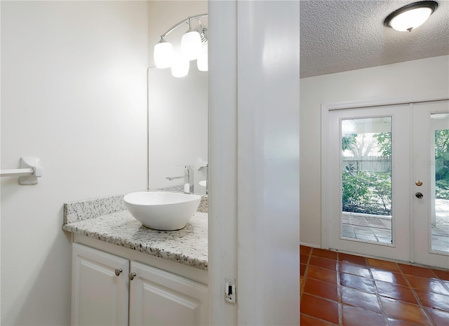 945 Hamilton Ct, Palm Harbor, FL 34683 - bathroom with vanity, tile patterned floors, and a textured ceiling