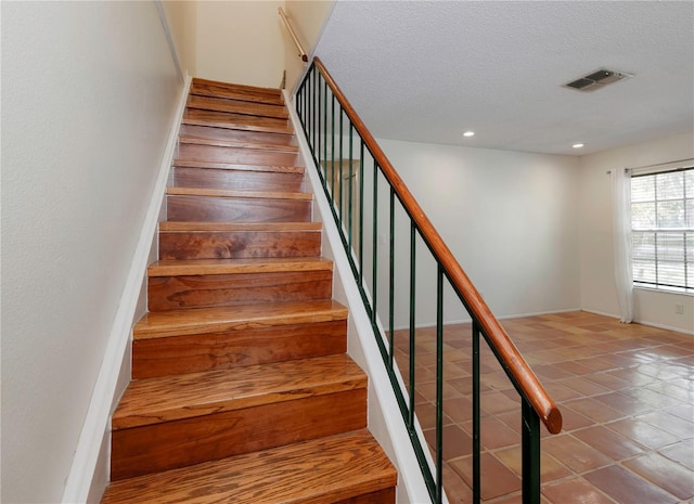 945 Hamilton Ct, Palm Harbor, FL 34683 - stairway featuring a textured ceiling, recessed lighting, and tile patterned floors