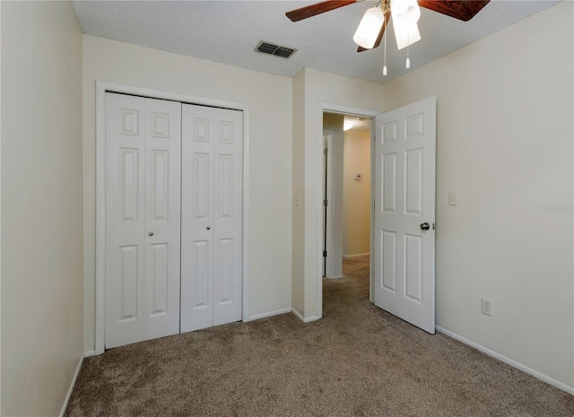 945 Hamilton Ct, Palm Harbor, FL 34683 - unfurnished bedroom with carpet, a closet, a ceiling fan, and a textured ceiling