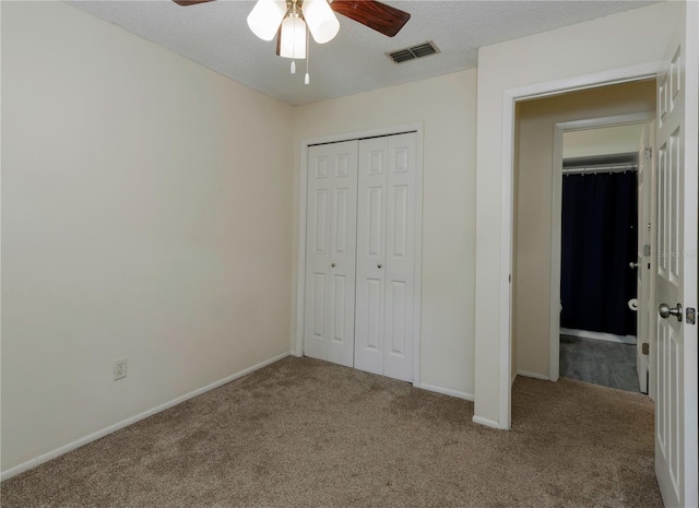 945 Hamilton Ct, Palm Harbor, FL 34683 - unfurnished bedroom featuring carpet, a closet, a textured ceiling, and ceiling fan