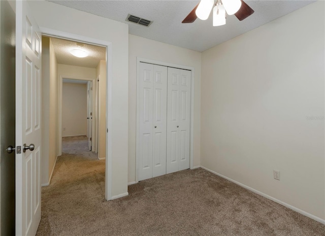 945 Hamilton Ct, Palm Harbor, FL 34683 - unfurnished bedroom featuring carpet floors, a closet, and ceiling fan