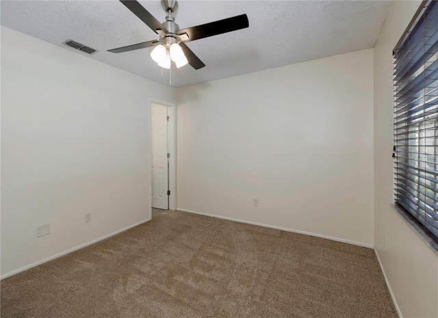 945 Hamilton Ct, Palm Harbor, FL 34683 - unfurnished room with carpet flooring, ceiling fan, and a textured ceiling