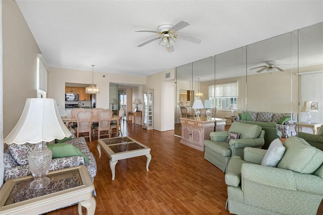 7892 Sailboat Key Blvd S Unit 408, South Pasadena, FL 33707 - living area featuring ceiling fan, wood finished floors, and a textured ceiling