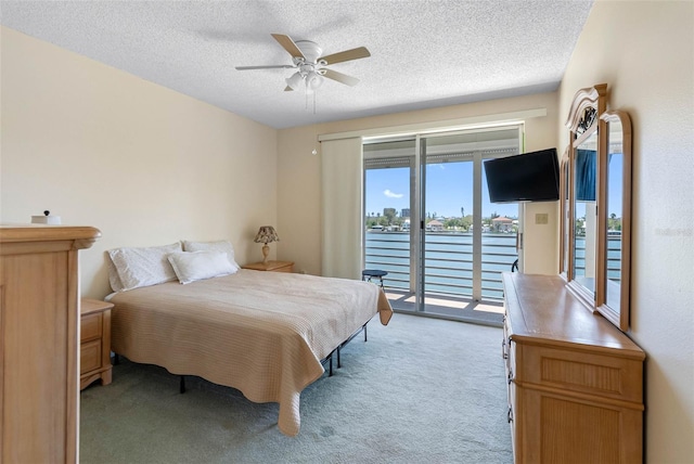 7892 Sailboat Key Blvd S Unit 408, South Pasadena, FL 33707 - bedroom featuring access to exterior, light carpet, a textured ceiling, and a ceiling fan
