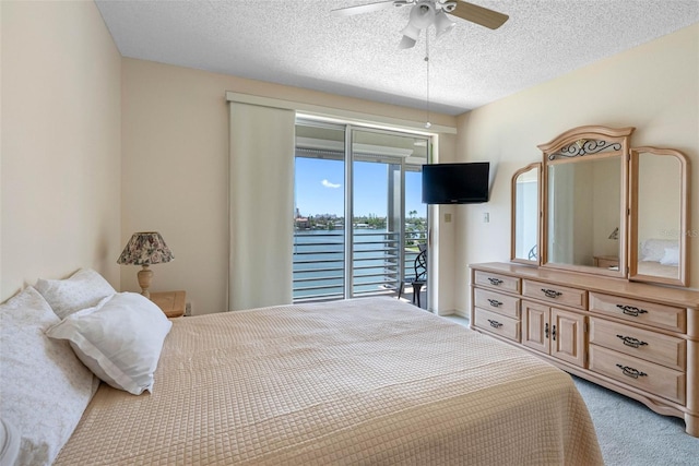 7892 Sailboat Key Blvd S Unit 408, South Pasadena, FL 33707 - bedroom featuring access to outside, light carpet, a textured ceiling, and ceiling fan