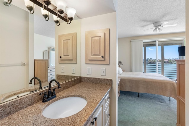 7892 Sailboat Key Blvd S Unit 408, South Pasadena, FL 33707 - ensuite bathroom featuring ceiling fan, vanity, and a textured ceiling