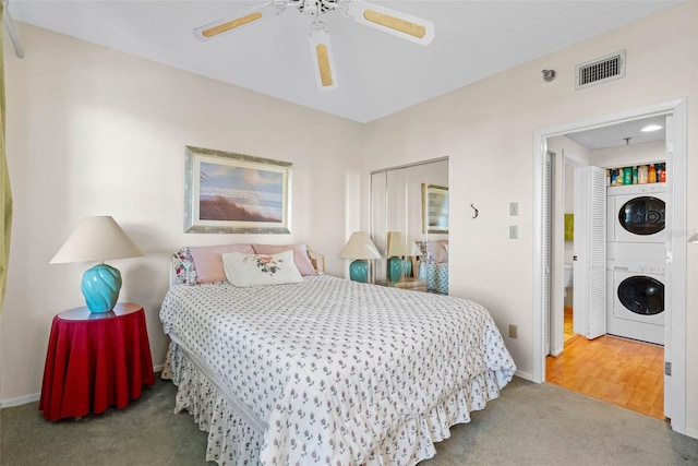 7892 Sailboat Key Blvd S Unit 408, South Pasadena, FL 33707 - carpeted bedroom with stacked washer / drying machine and ceiling fan