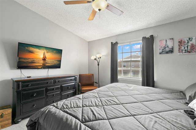 6681 121st Ave Unit I, Largo, FL 33773 - bedroom with a textured ceiling, vaulted ceiling, carpet, and ceiling fan