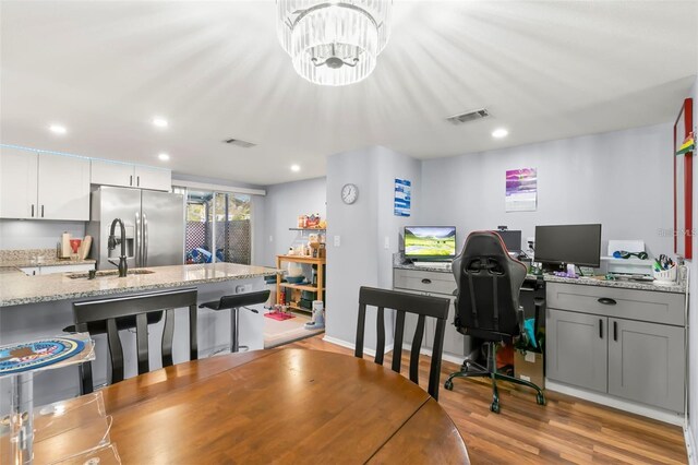 6681 121st Ave Unit I, Largo, FL 33773 - dining room with an office area, light wood-style floors, recessed lighting, and a chandelier