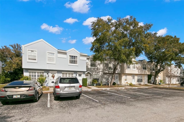 6681 121st Ave Unit I, Largo, FL 33773 - view of front facade featuring uncovered parking, stucco siding, and a residential view