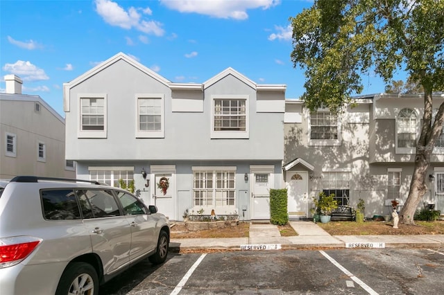 6681 121st Ave Unit I, Largo, FL 33773 - view of property featuring uncovered parking and stucco siding