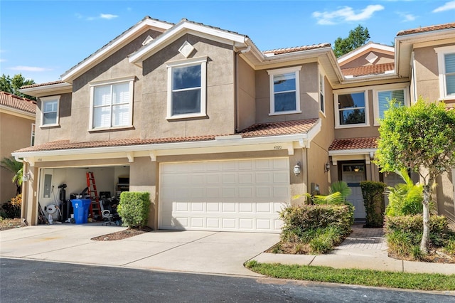 4920 Anniston Cir, Tampa, FL 33647 - multi unit property featuring a tiled roof, stucco siding, driveway, and an attached garage