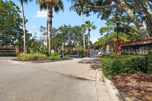 4920 Anniston Cir, Tampa, FL 33647 - view of street with curbs, a gated entry, and street lights
