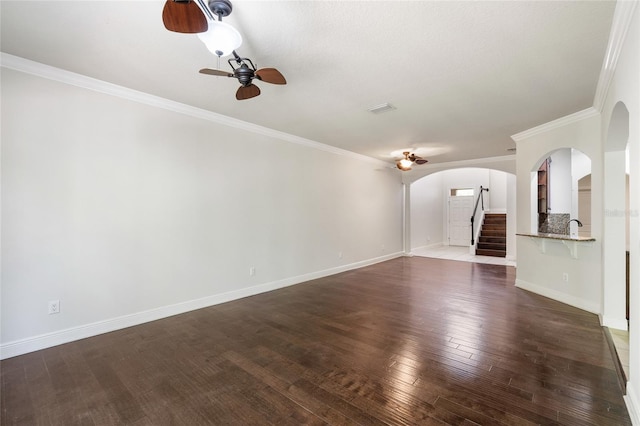 4920 Anniston Cir, Tampa, FL 33647 - unfurnished living room with arched walkways, ceiling fan, stairs, dark wood-style flooring, and crown molding
