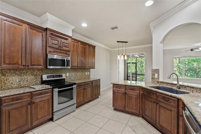 4920 Anniston Cir, Tampa, FL 33647 - kitchen featuring stainless steel appliances, backsplash, light stone counters, light tile patterned floors, and ornamental molding
