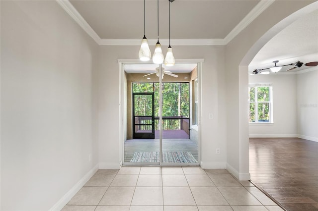 4920 Anniston Cir, Tampa, FL 33647 - unfurnished dining area with a ceiling fan, arched walkways, crown molding, and light wood-style floors