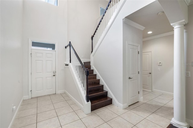 4920 Anniston Cir, Tampa, FL 33647 - foyer with light tile patterned floors, ornate columns, stairs, ornamental molding, and a high ceiling