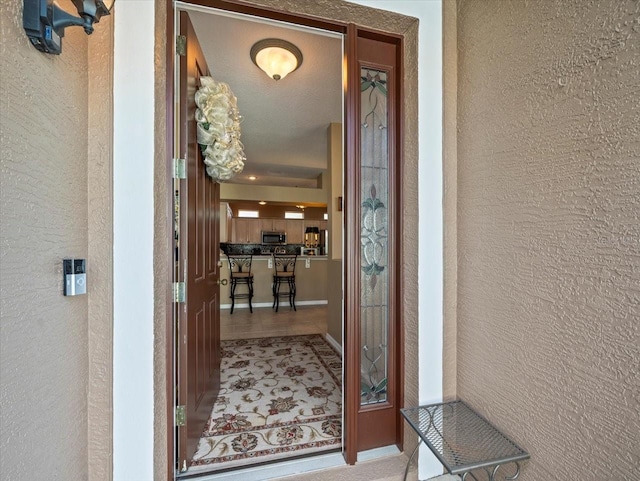 7606 Berna Ln, Land O Lakes, FL 34637 - doorway to property featuring stucco siding