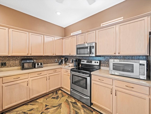 7606 Berna Ln, Land O Lakes, FL 34637 - kitchen featuring stainless steel appliances, light brown cabinetry, decorative backsplash, and light countertops