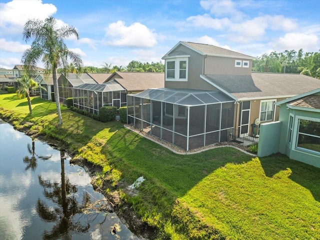 7606 Berna Ln, Land O Lakes, FL 34637 - back of house featuring a lawn, stucco siding, glass enclosure, a shingled roof, and a water view