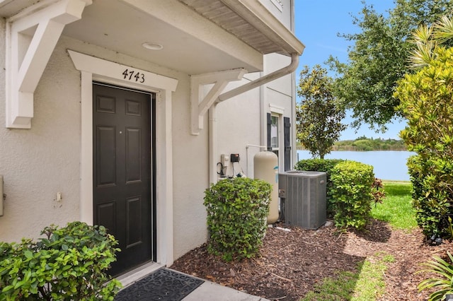 4743 Somerset Hill Ln, Riverview, FL 33578 - doorway to property featuring stucco siding and a water view