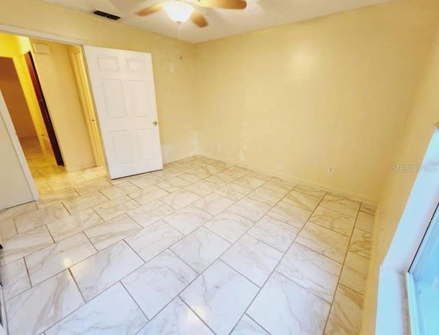 1918 Crown Park Dr, Valrico, FL 33594 - unfurnished bedroom with light marble finish flooring and a ceiling fan