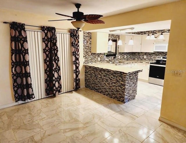 1918 Crown Park Dr, Valrico, FL 33594 - kitchen featuring range, white microwave, light marble finish floors, white cabinetry, and a peninsula