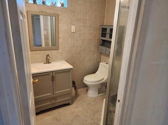 1918 Crown Park Dr, Valrico, FL 33594 - bathroom featuring vanity, tile walls, tile patterned flooring, and a stall shower