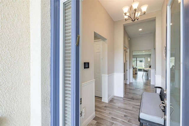 12652 Shetland Walk Dr, Lithia, FL 33547 - hallway featuring a chandelier, wainscoting, and light wood-type flooring