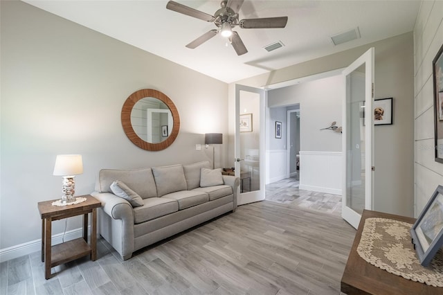 12652 Shetland Walk Dr, Lithia, FL 33547 - living room with ceiling fan, french doors, wainscoting, and light wood-type flooring