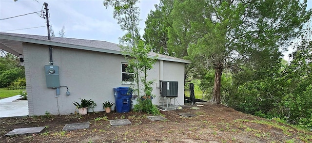 7332 Janczlik Dr, New Port Richey, FL 34652 - view of side of home featuring stucco siding and a central air condition unit