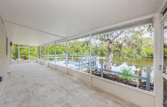 7332 Janczlik Dr, New Port Richey, FL 34652 - unfurnished sunroom featuring a water view, plenty of natural light, and view of scattered trees