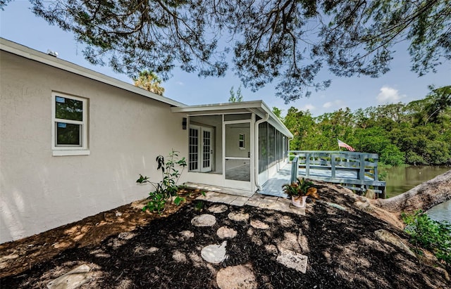 7332 Janczlik Dr, New Port Richey, FL 34652 - view of side of home featuring a sunroom and stucco siding
