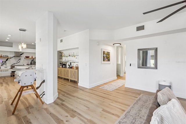1802 Regal Mist Loop, Trinity, FL 34655 - living area featuring light wood-type flooring, a ceiling fan, arched walkways, and recessed lighting