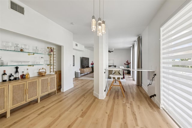 1802 Regal Mist Loop, Trinity, FL 34655 - dining area with light wood finished floors, a dry bar, and a chandelier